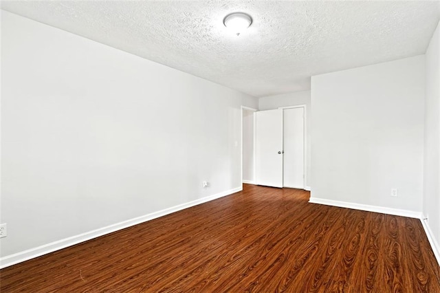 2199 Summertown Dr, Norcross, GA 30071 - empty room with dark wood finished floors, a textured ceiling, and baseboards