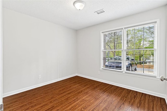 2199 Summertown Dr, Norcross, GA 30071 - empty room featuring dark wood finished floors, plenty of natural light, baseboards, and a textured ceiling