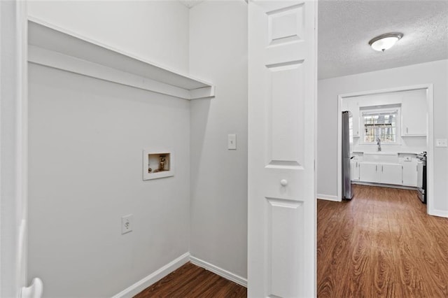 2199 Summertown Dr, Norcross, GA 30071 - washroom featuring hookup for a washing machine, dark wood finished floors, baseboards, a textured ceiling, and a sink