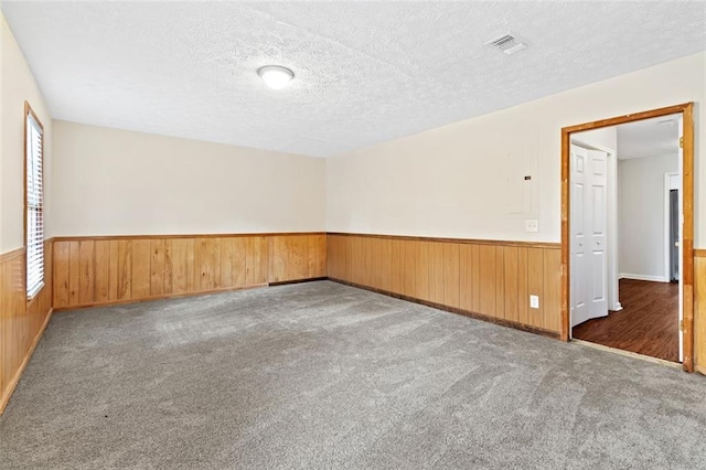 2199 Summertown Dr, Norcross, GA 30071 - empty room featuring wainscoting, wood walls, a textured ceiling, and carpet flooring