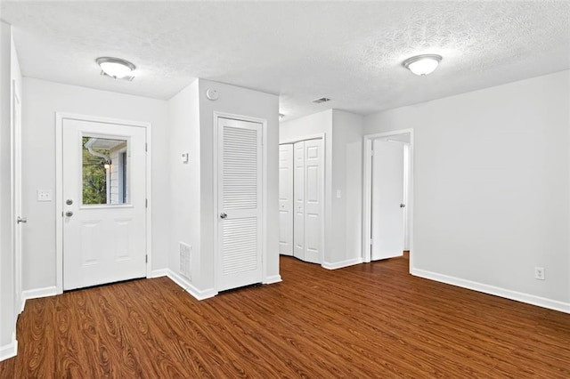2199 Summertown Dr, Norcross, GA 30071 - entrance foyer with dark wood-style flooring, a textured ceiling, and baseboards