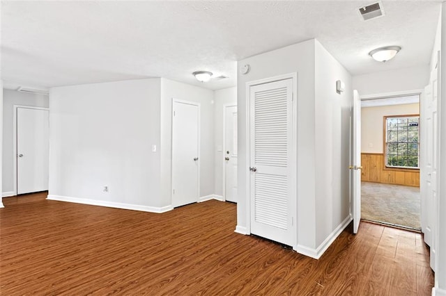 2199 Summertown Dr, Norcross, GA 30071 - spare room with wood finished floors, a textured ceiling, a wainscoted wall, and baseboards