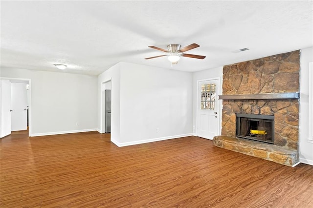 2199 Summertown Dr, Norcross, GA 30071 - unfurnished living room with wood finished floors, ceiling fan, baseboards, and a fireplace