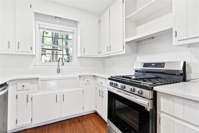 2199 Summertown Dr, Norcross, GA 30071 - kitchen with appliances with stainless steel finishes, a sink, light countertops, white cabinetry, and decorative backsplash