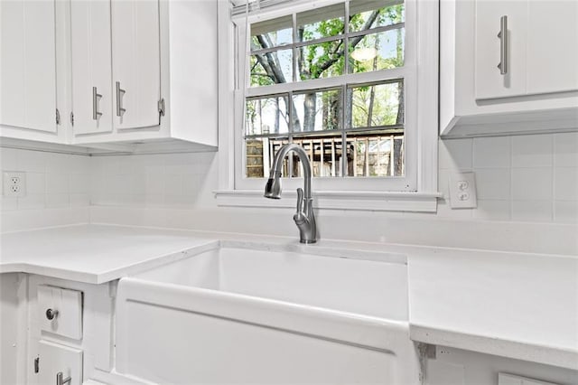 2199 Summertown Dr, Norcross, GA 30071 - kitchen featuring a sink, light countertops, white cabinets, and tasteful backsplash