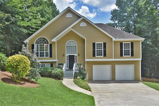 split foyer home featuring a garage and a front lawn