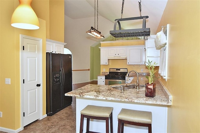 kitchen with stainless steel range with gas cooktop, white cabinetry, sink, hanging light fixtures, and black fridge with ice dispenser