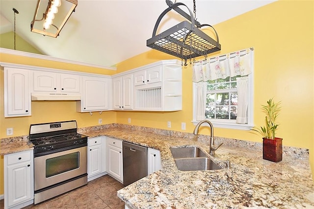 kitchen with sink, appliances with stainless steel finishes, white cabinetry, light stone counters, and kitchen peninsula