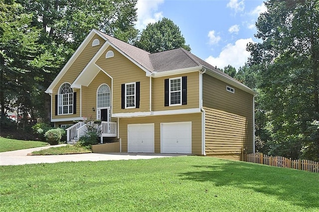 bi-level home with a garage and a front lawn