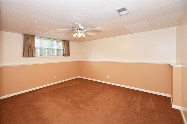 unfurnished room featuring ceiling fan, carpet, and a drop ceiling