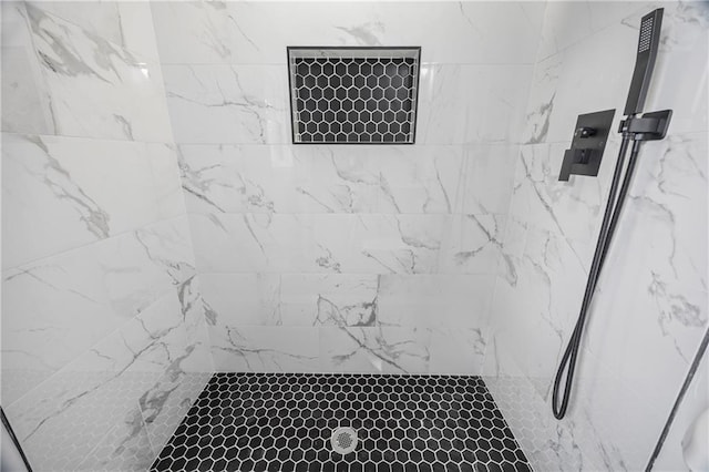 bathroom with tiled shower