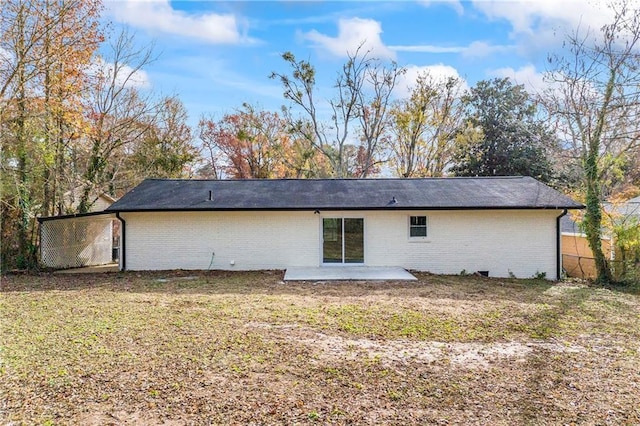 rear view of property with a yard and a patio area