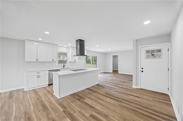 kitchen featuring a center island, sink, stainless steel dishwasher, island range hood, and white cabinetry