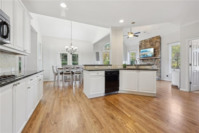 kitchen featuring tasteful backsplash, white cabinetry, stainless steel appliances, and vaulted ceiling