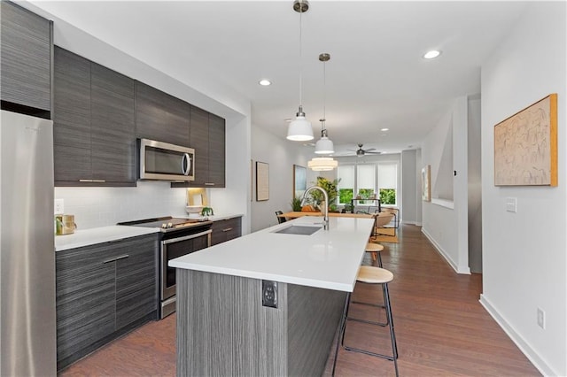 415 Gartrell St SE Unit 15, Atlanta, GA 30312 - kitchen featuring stainless steel appliances, ceiling fan, a kitchen breakfast bar, light countertops, and recessed lighting