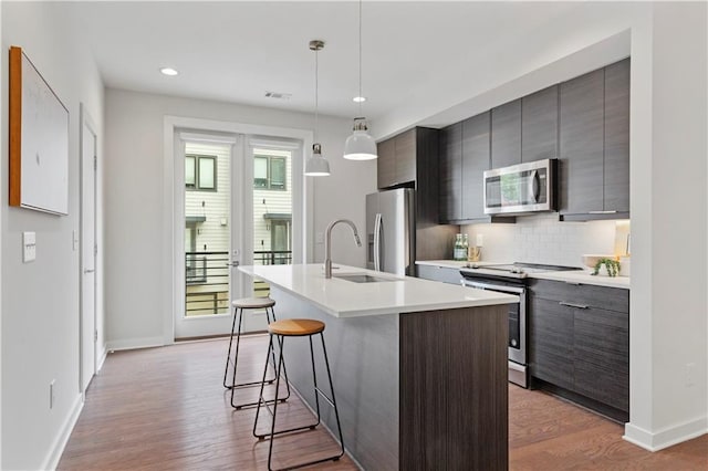 415 Gartrell St SE Unit 15, Atlanta, GA 30312 - kitchen featuring stainless steel appliances, a kitchen breakfast bar, modern cabinets, a center island with sink, and recessed lighting