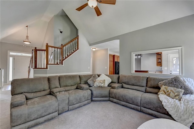 carpeted living room with high vaulted ceiling and ceiling fan