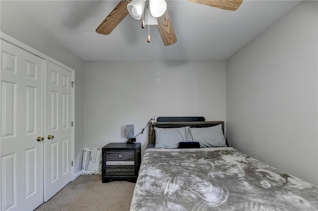 carpeted bedroom featuring ceiling fan and a closet