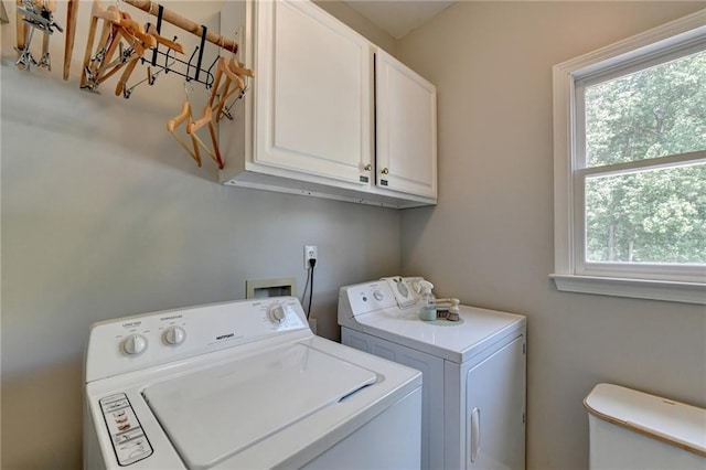 laundry room with cabinets and separate washer and dryer