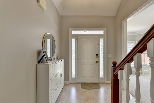 foyer entrance with vaulted ceiling and light tile patterned flooring