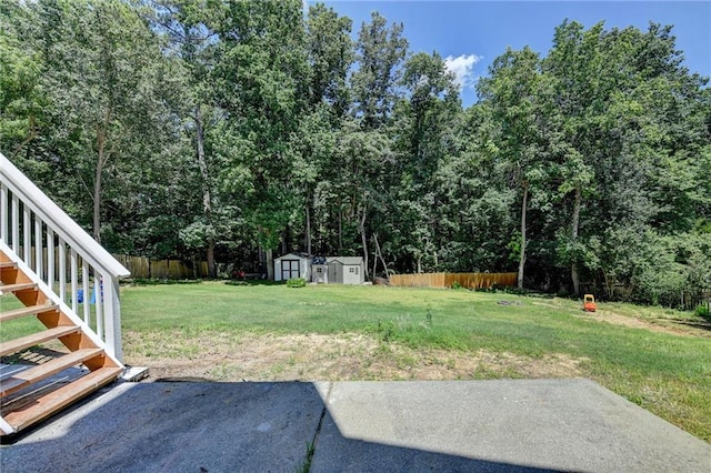 view of yard featuring a storage unit and a patio