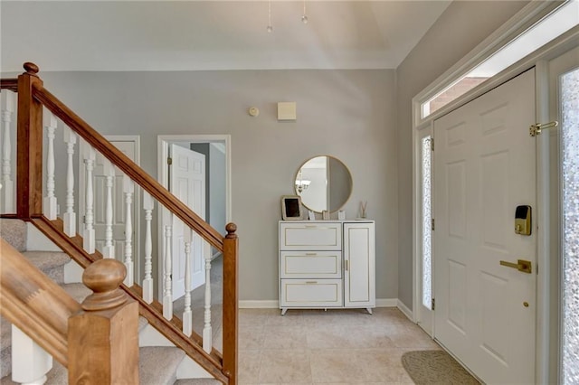 foyer entrance with light tile patterned flooring