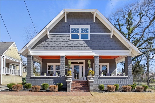 view of front of house featuring a porch and brick siding