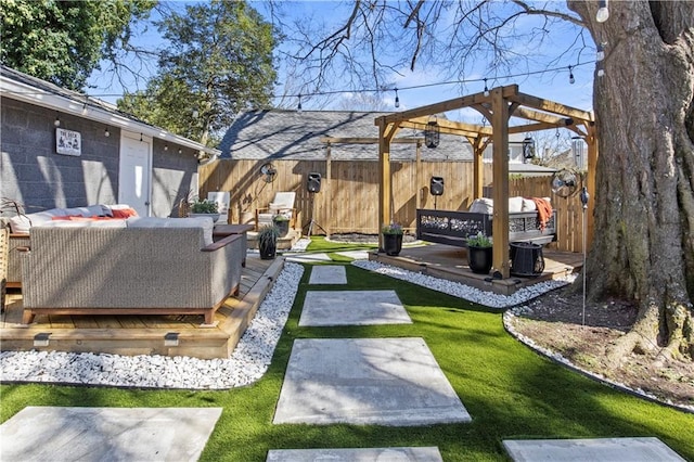 view of yard featuring a wooden deck, an outdoor hangout area, a pergola, and fence