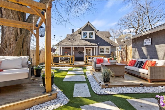 back of house with fence, roof with shingles, a wooden deck, an outdoor living space, and a chimney