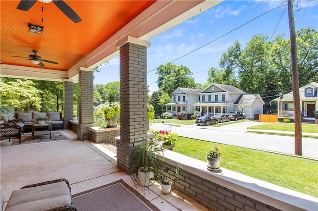 view of patio with outdoor lounge area, a ceiling fan, and covered porch