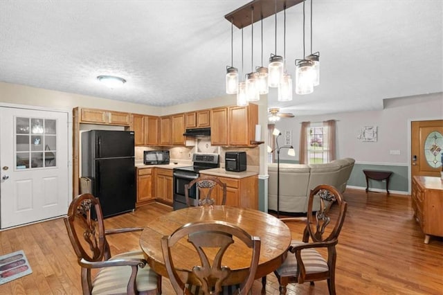 75 Mcpherson Ln, Bremen, GA 30110 - dining area featuring light wood-style flooring, a textured ceiling, and a chandelier
