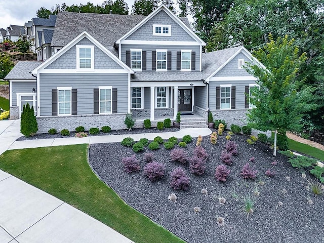 view of front of home featuring a front yard and roof with shingles