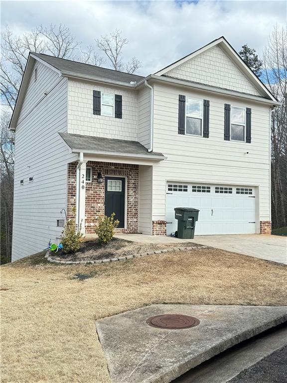 240 Sugar Maple Dr, Cornelia, GA 30531 - view of front of house with brick siding, a garage, concrete driveway, and a shingled roof