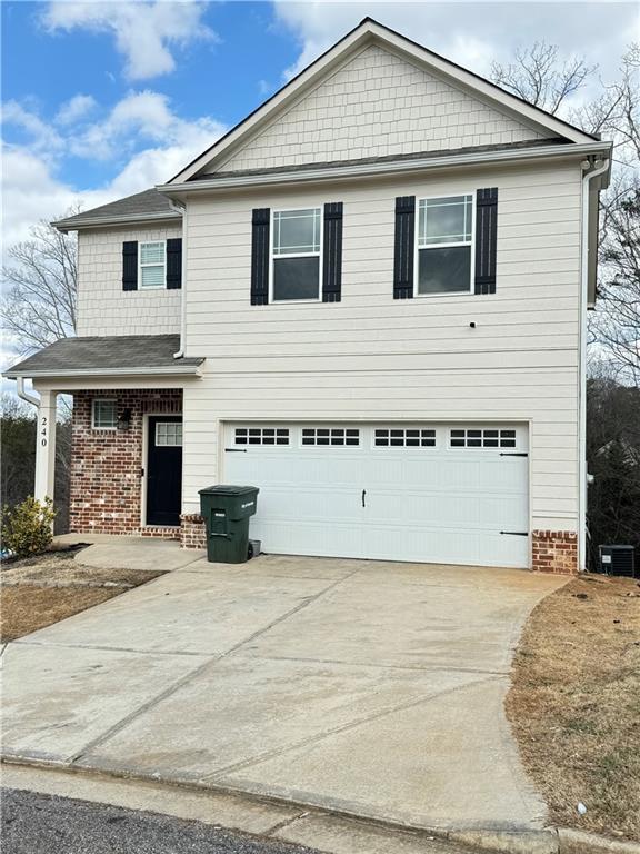 240 Sugar Maple Dr, Cornelia, GA 30531 - traditional-style home with brick siding, a garage, and driveway