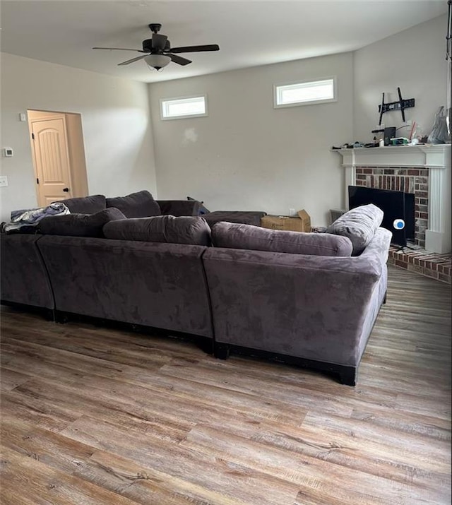 240 Sugar Maple Dr, Cornelia, GA 30531 - living area featuring a ceiling fan, plenty of natural light, wood finished floors, and a brick fireplace