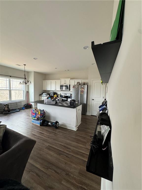 240 Sugar Maple Dr, Cornelia, GA 30531 - kitchen with appliances with stainless steel finishes, white cabinets, dark countertops, dark wood-style flooring, and recessed lighting