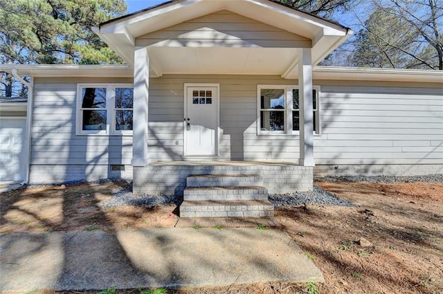 view of exterior entry featuring a porch