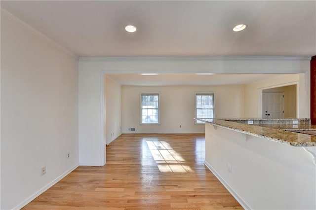 interior space featuring ornamental molding and light hardwood / wood-style flooring