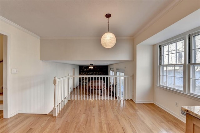 interior space featuring crown molding and light hardwood / wood-style flooring