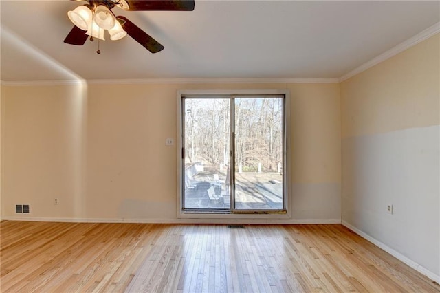 spare room featuring ornamental molding, ceiling fan, and light wood-type flooring