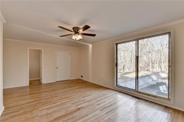 unfurnished room featuring ornamental molding, ceiling fan, and light wood-type flooring