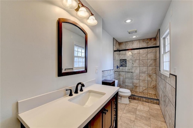 bathroom featuring vanity, toilet, and an enclosed shower