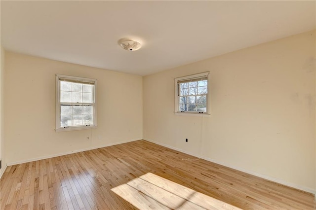 empty room with light hardwood / wood-style floors