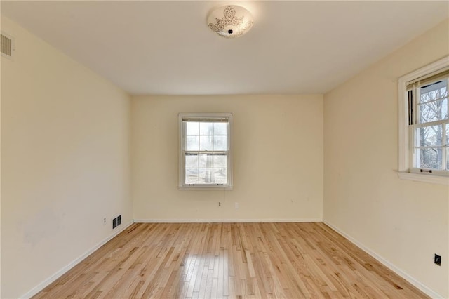 unfurnished room with light hardwood / wood-style flooring