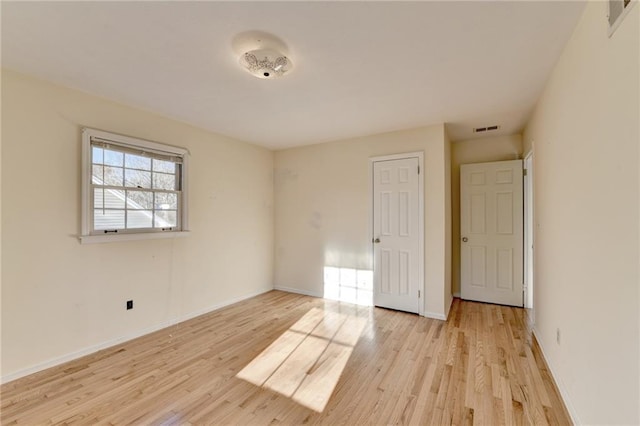 unfurnished room featuring light hardwood / wood-style floors