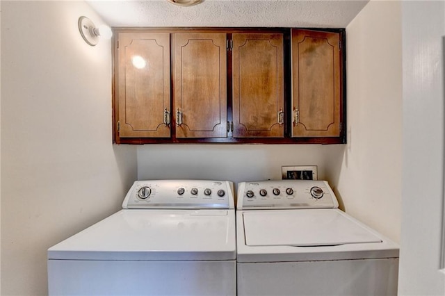 laundry area featuring independent washer and dryer and a textured ceiling