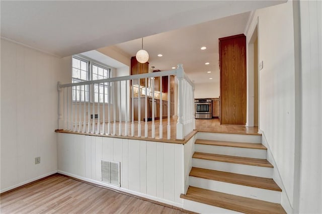 stairway with hardwood / wood-style flooring