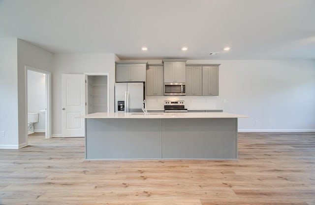 3151 Washburn St SW, Atlanta, GA 30354 - kitchen featuring stainless steel appliances, gray cabinets, a center island with sink, a sink, and light countertops