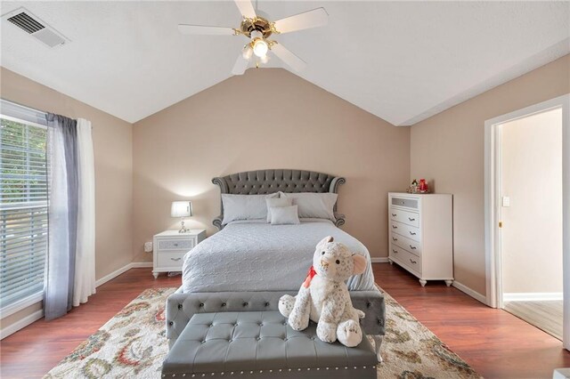 bedroom with hardwood / wood-style floors, ceiling fan, and lofted ceiling