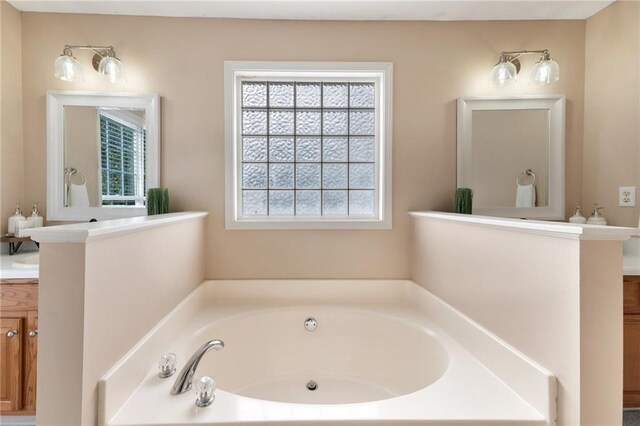 bathroom featuring vanity and a tub